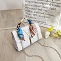 White quilted crossbody bag with golden V-logo, fringe detail and silk scarf handle - White