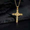 Macro shot of gold cross pendant necklace with white zircons on dark stone base - Gold Hollow Vintage Cross (款式67)