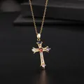 Macro view of a gold cross pendant featuring a red center stone and multicolor zircon gems - Gold Colorful Religious Vintage (款式69)