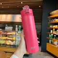 Vaso térmico Tyeso rojo rosa con acabado mate y tapa abatible en un entorno de café - 600ml / Rosa Rojo
