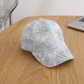 Close-up of acid wash denim baseball cap with sunflower rhinestones on wooden table - Child Style (Adjustable) / Blue