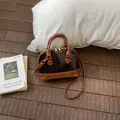 Elegant brown shell bag in patent leather and snakeskin pattern with gold hardware - Brown