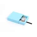 Sky blue drawer jewelry box with black ribbon pull showing a gold screw-motif bangle - Light Blue Floating Box + Drawer Box / 70*70*20mm