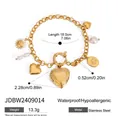 Gold stainless steel multi-charm bracelet featuring heart locket and sun pendant - Vintage Engraved Locket and Paw Disk Style