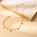 Detailed shot of gold sun pendants and round cubic zirconia on a delicate link chain necklace - Sun Pendant (X634) / Gold