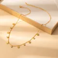 Close-up of gold-plated petal necklace with round rhinestones on a beige display box - Five-petal Flower (X635) / Gold