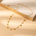 Detail of gold cherry pendant necklace with crystals on an elegant display tray - Cherry Style (X642) / Gold