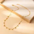 Detailed close-up of golden petal pendant necklace with lobster clasp and extension chain - Eye Style (X646) / Gold
