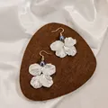 Elegant white petal flower earrings with dark pearl accent in a stylish golden hook finish - Grey Center Bead White Petal Style (E6057-2/Grey)