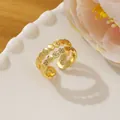 Close-up of golden honeycomb open ring with micro-paved crystals on white ceramic tray - Adjustable Open / Gold Multi-layer Honeycomb Geometric Style (I)