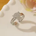 Close-up of silver-tone candy-shaped ring with pavé zircons on a wavy ceramic plate - Adjustable Open / Silver Candy Shape Pavé Style (T)