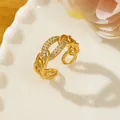 Detail of gold chain link ring with micro-paved rhinestones on a ceramic dish - Adjustable Open / Gold Thick Chain Shape Pavé Style (A1)