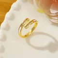 Detail of gold open ring with rectangle zircons and white enamel on a white ceramic plate - Adjustable Open / Gold Wrap-around Shell Detail Style (G1)