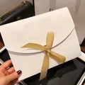 Elegant white envelope gift box featuring a gold satin ribbon bow held by hand - Set of 3 / White Gift Box