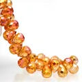 Macro shot of faceted amber glass teardrop beads showing precision cut and high refraction - Burgundy / 6mm (approximately 87 Beads Per Strip)