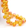Close-up of faceted amber K9 crystal teardrop beads for DIY jewelry making - Gold Rose Red / 6mm (approximately 87 Beads Per Strip)