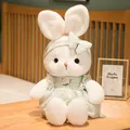 Cute white bunny plush toy wearing a green checkered dress and matching floral headband - Green Dress / Small