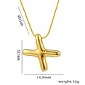 Minimalist gold puffy cross necklace with dimensions on a polished snake chain - Cross