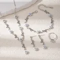 Detail view of a rose jewelry set with silver base and light blue floral accents - Necklace Bracelet Earrings And Ring Set (E4421-5) / Silver/White