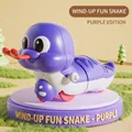 Purple wind-up snake toy for kids featuring a swinging motion and cute cartoon design - Wind-up Fun Snake (Purple)