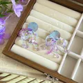 Silver needle tassel earrings with purple flower beads displayed in a wooden jewelry box - Blue Purple Bead Tassel Ear Clip (31#)