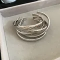Silver-toned open bangle featuring a unique hammered crumpled metal texture - Wrinkled Hammered Design / Silver