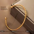 Detail of 18K gold plated stainless steel spiral cuff bracelet with ball ends - Gold Wire Wrap Style
