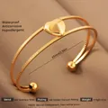 Macro view of 18k gold plated stainless steel heart bangle showing dual band detail - Gold Heart Texture Style (39)