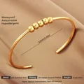 Macro detail of 18k gold plated stainless steel hollow bangle showing size and specs - Gold Five Sphere Style