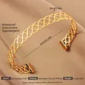 Macro detail of 18k gold plated stainless steel hollow woven cuff bracelet with 9mm width - Gold Interlaced Wave Style (65)