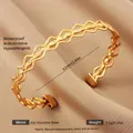 Detailed view of adjustable 18k gold wave bangle showing 304 stainless steel texture - Gold Wavy Interlaced Texture Style