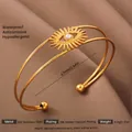 Elegant 18k gold plated stainless steel open bangle with sunburst pearl centerpiece - Gold Sun Eye Artificial Pearl Style