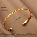 Braided texture 18K gold plated stainless steel open bangle with bead ends on brown silk - Gold Chain Style