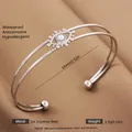 Silver evil eye open bangle with pearl center in 304 stainless steel and satin background - Silver Daisy Inlaid Pearl Style