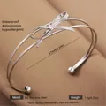 Silver stainless steel open cuff bracelet with a woven bow design in polished 304 steel - Silver Bow Fragment Style