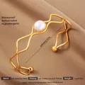 Exaggerated 18k gold plated stainless steel wave bangle with white pearl inlay for women - Gold Wave Artificial Pearl Style (44)