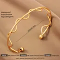 Exaggerated wavy 18k gold plated stainless steel open bangle for women in golden finish - Gold Wavy Stainless Steel Style (54)