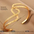 Adjustable 18k gold plated stainless steel knot bangle with a hollow twisted design - Gold Double Z Wave Texture Style