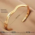 Adjustable wavy 18K gold plated stainless steel cuff bracelet in a bright finish - Gold Irregular Polished Style
