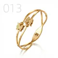 Detailed macro view of gold-plated butterfly bangle with frosted texture and snap closure - Double Line Frosted Butterfly Round Bead Style (013)