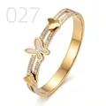 Macro detail of gold butterfly cuff bracelet featuring pavé zircon and white enamel butterfly - Double Track Hollow Mother of Pearl Pave Butterfly Style (027)