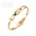 Polished gold butterfly bangle with matte accents and spring hinge on white background - Black and White Mother of Pearl Frosted Multi-butterfly Style (039)