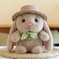 Cute light brown plush bunny wearing a small sun hat and a floral green bow tie - Brown