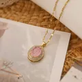 Elegant gold-plated necklace featuring a pink stone oval pendant and dainty chain. - Pink