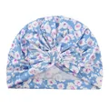 Close-up of floral baby turban hat featuring a large bow and soft blue cotton fabric - Blue & White Floral (F)