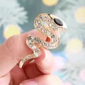 Luxurious gold-toned snake brooch featuring sparkling clear rhinestones and black eye - Gold with White Zircon