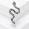Sparkling snake-shaped brooch adorned with purple and blue rhinestones on white display - Silver With Colorful Zircon