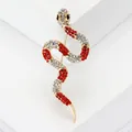 Elegant S-shaped snake brooch encrusted with vibrant red and white crystals in gold finish - Gold With Red And White Zirconia