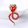 Elegant golden cobra snake brooch with sparkling red heart rhinestone inlay - Gold with Red Rhinestones