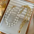 Minimalist double-layer pearl and gold chain necklace with a padlock pendant on display - Gold Necklace